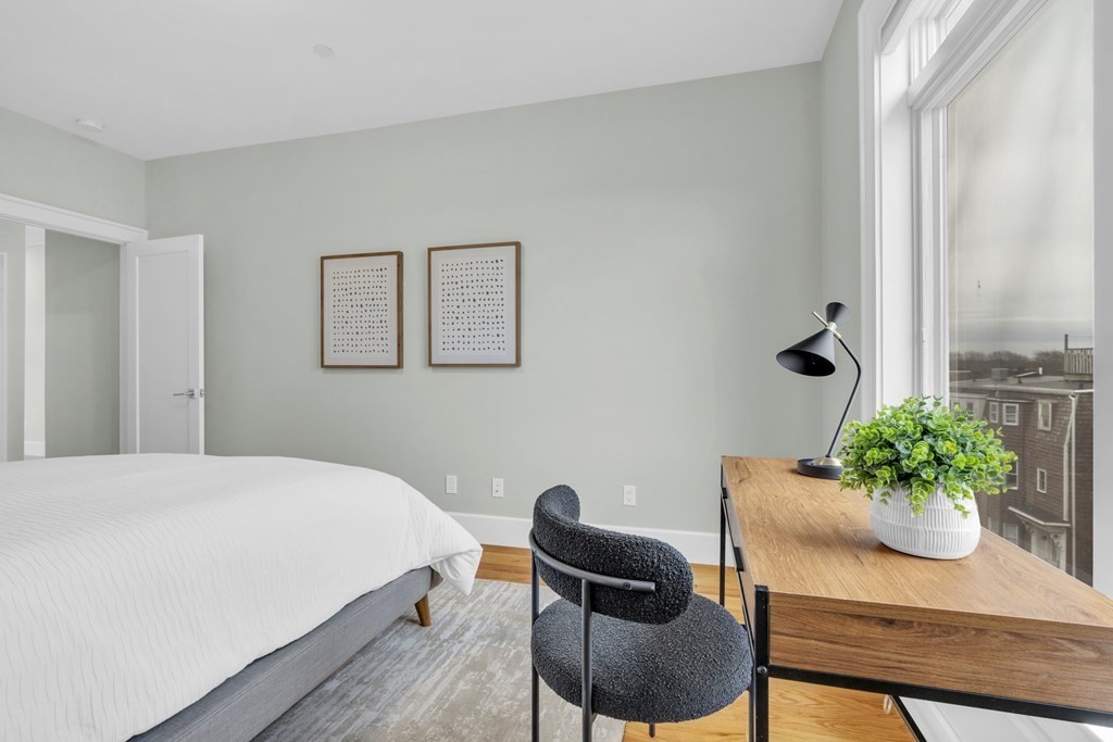 17 Vinton Street, Unit PH Boston, MA 02127 - Photo 30 of 36 a bedroom with a bed and a potted plant
