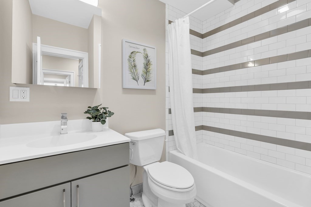 17 Vinton Street, Unit PH Boston, MA 02127 - Photo 31 of 36 a bathroom with a sink toilet vanity and tub