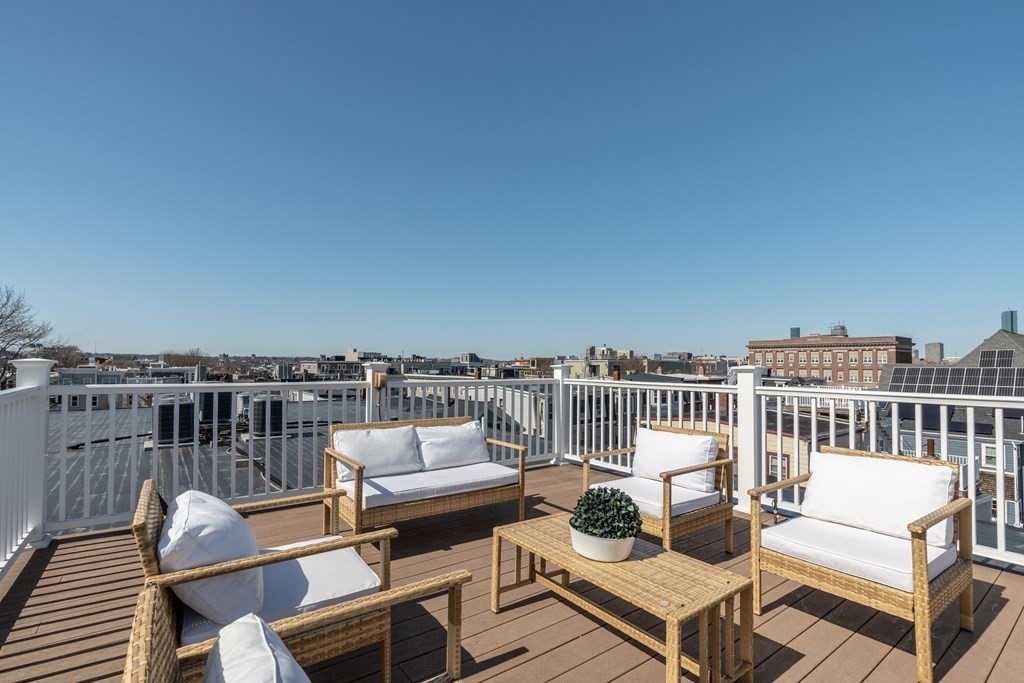 17 Vinton Street, Unit PH Boston, MA 02127 - Photo 32 of 36 a view of a balcony with wooden floor and a couches