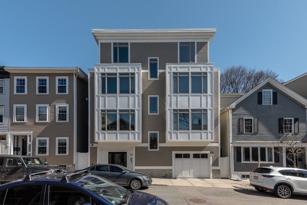 17 Vinton Street, Unit PH Boston, MA 02127 - Photo 34 of 36 a front view of a building with lot of cars and trees