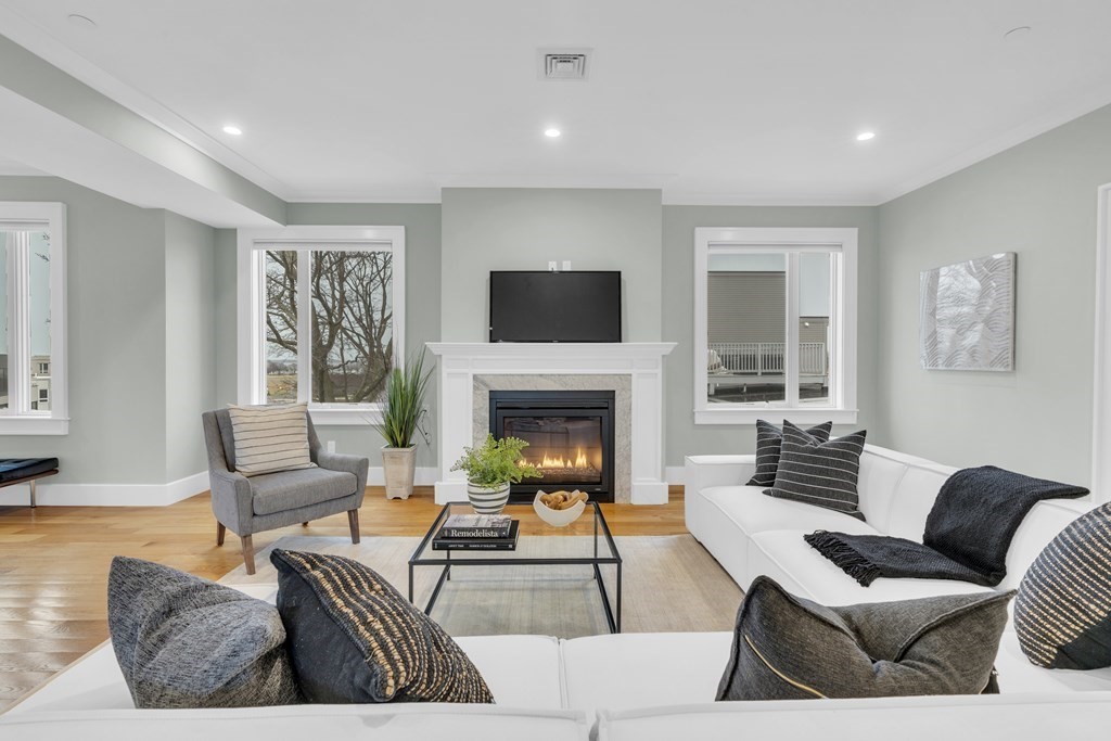 17 Vinton Street, Unit PH Boston, MA 02127 - Photo 4 of 36 a living room with furniture fireplace and a flat screen tv