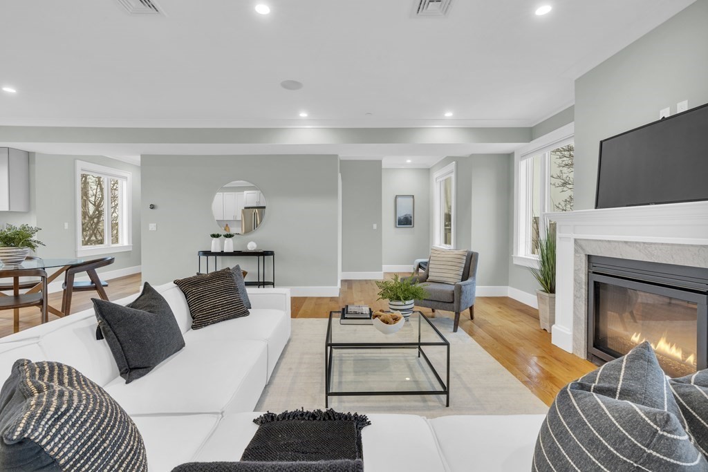 17 Vinton Street, Unit PH Boston, MA 02127 - Photo 5 of 36 a living room with furniture a fireplace and a flat screen tv