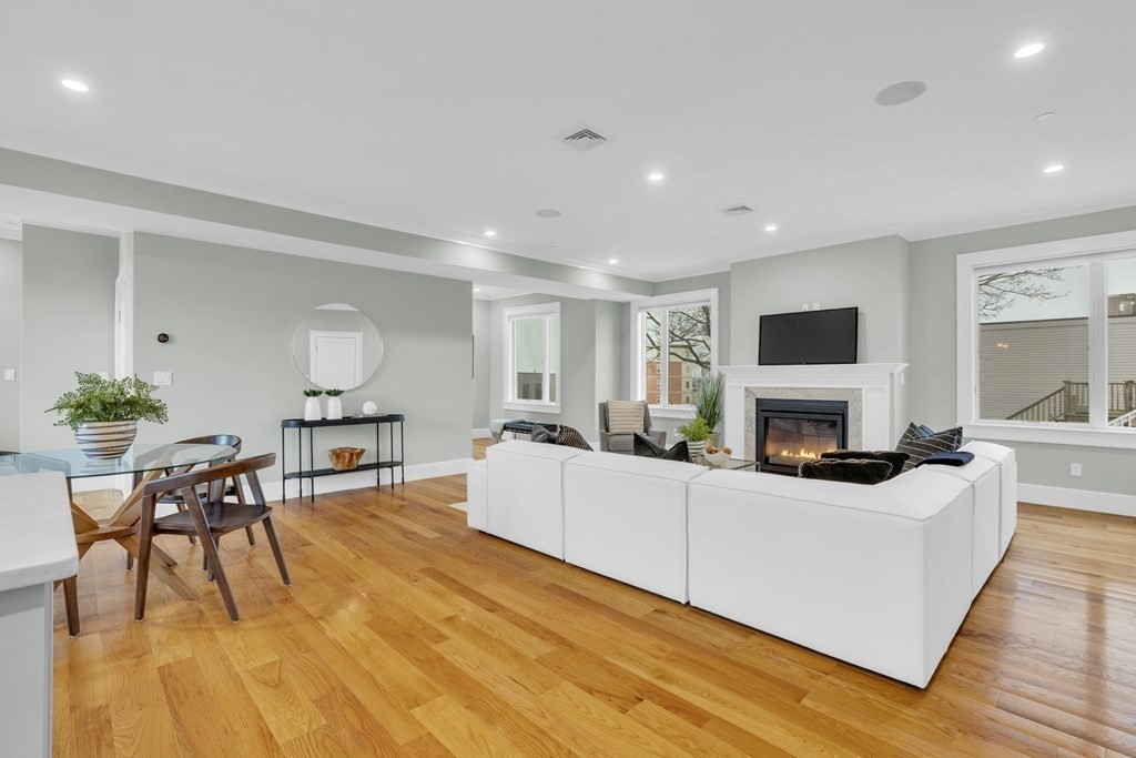 17 Vinton Street, Unit PH Boston, MA 02127 - Photo 7 of 36 a living room with furniture a fireplace and a flat screen tv