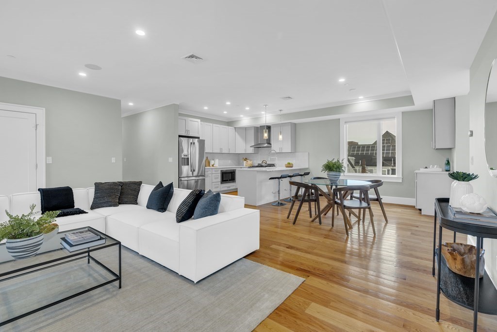 17 Vinton Street, Unit PH Boston, MA 02127 - Photo 8 of 36 a living room with furniture and a table