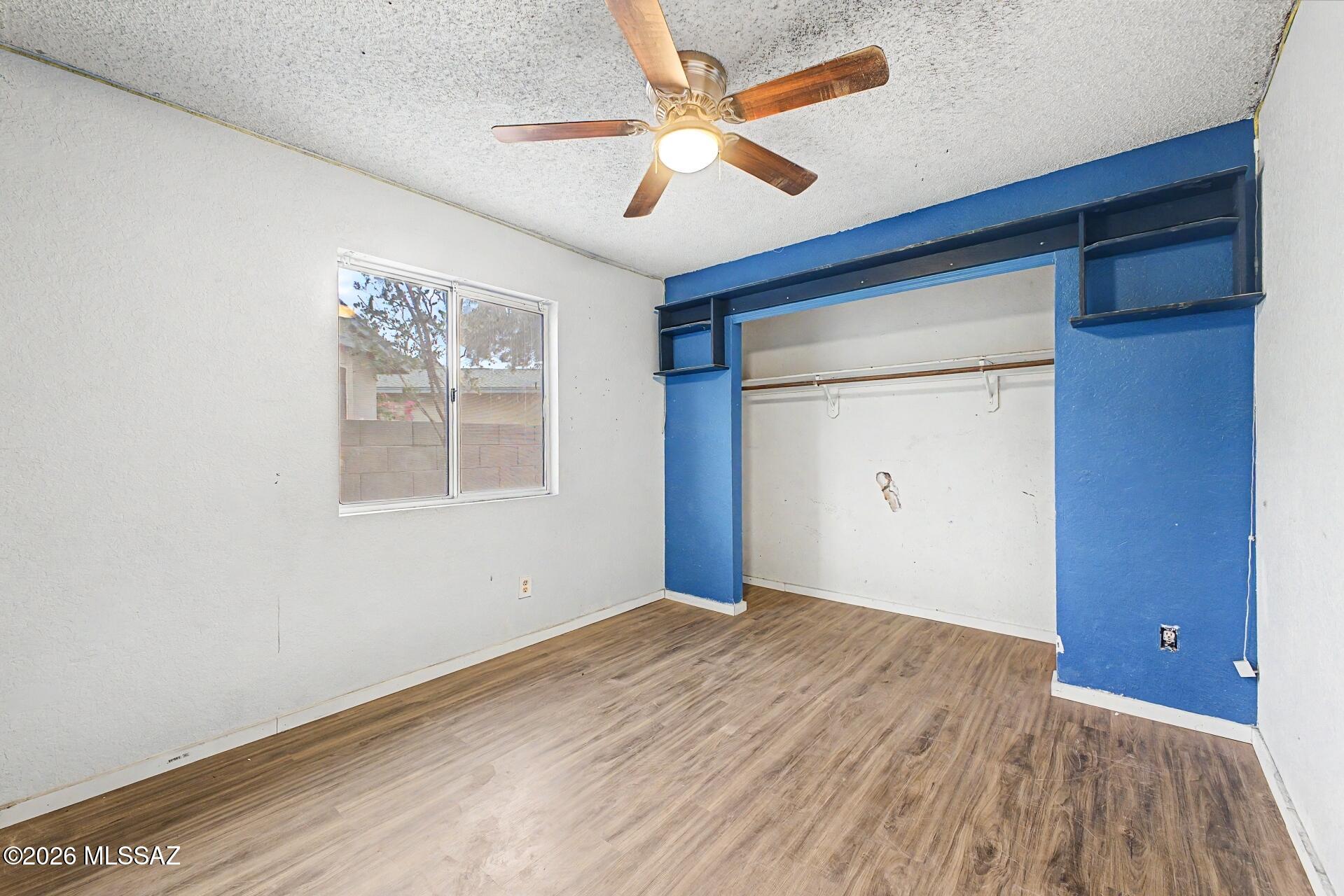 9810 East Stonehaven Way Tucson, AZ 85747 - Photo 20 of 27 a view of an empty room with a window and a ceiling fan