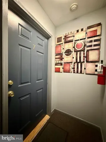 a kitchen with refrigerator and cabinets