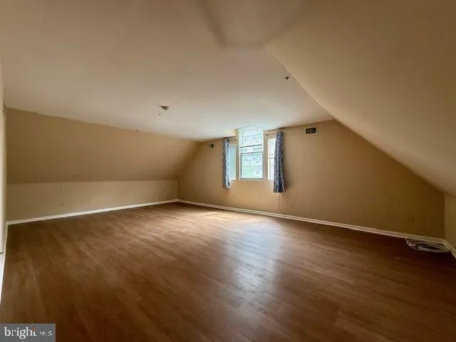 an empty room with wooden floor