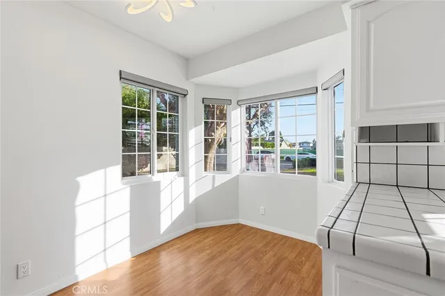 a view of a kitchen in an empty room with a window
