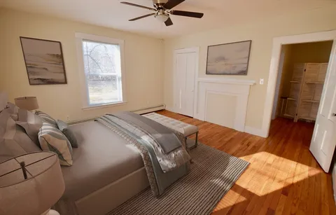 a bedroom with a bed and window