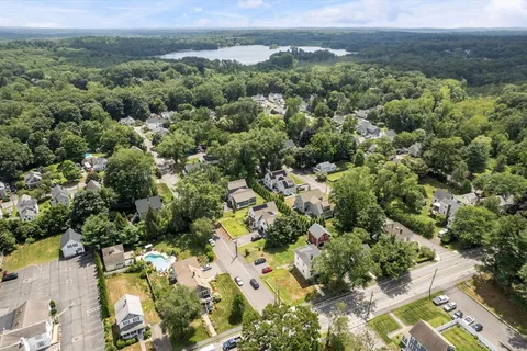 an aerial view of a houses with a yard
