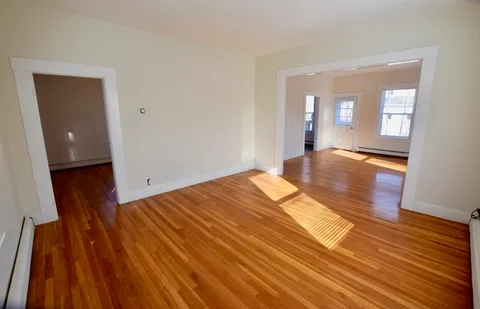 a view of a room with wooden floor and staircase