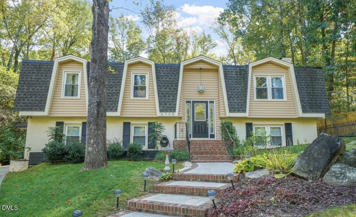 6708 Spencer Court Raleigh, NC 27615 - Photo 1 of 35 a front view of a house with garden