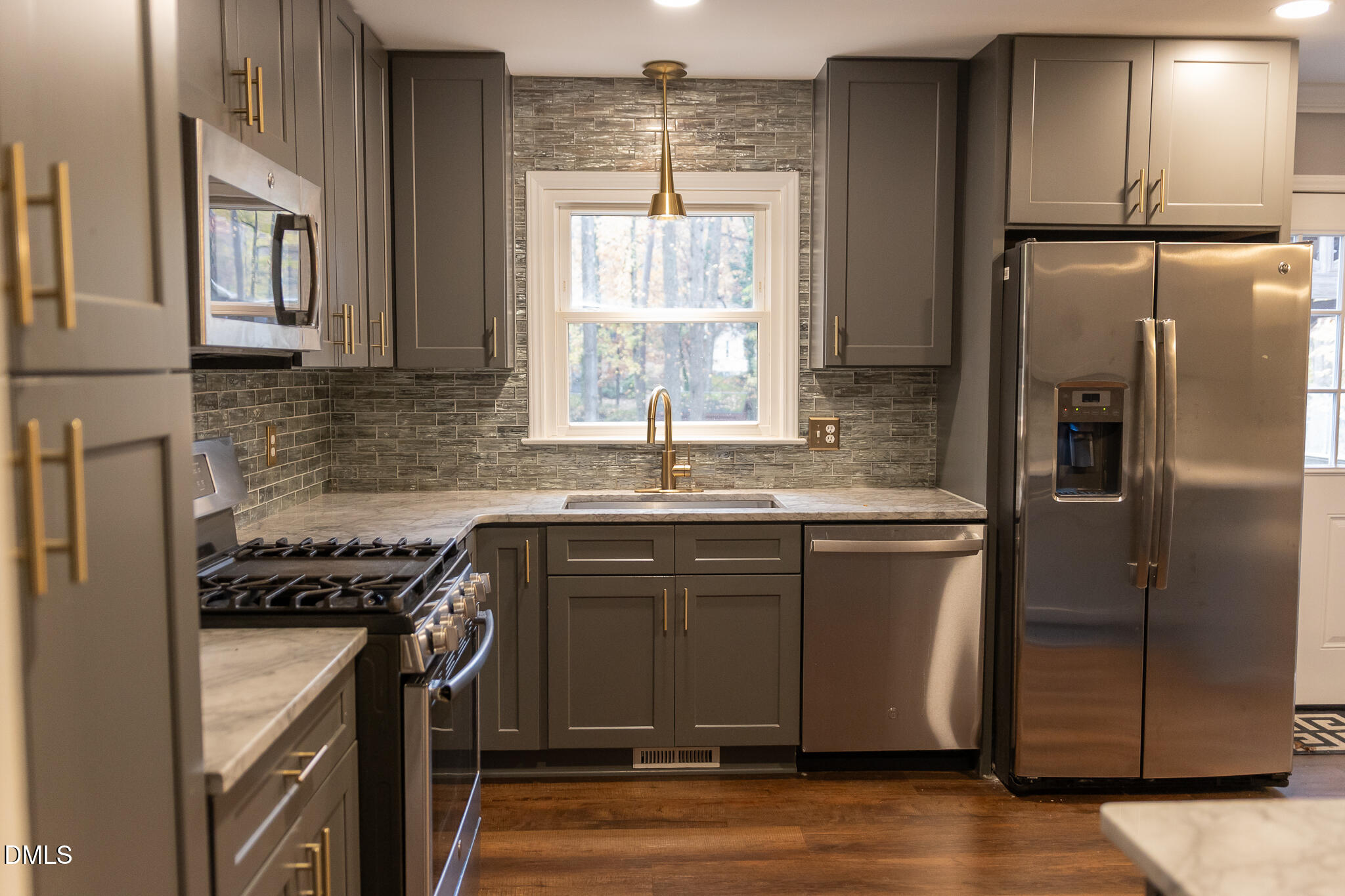 6708 Spencer Court Raleigh, NC 27615 - Photo 15 of 35 a kitchen with stainless steel appliances granite countertop a sink a stove a refrigerator and island