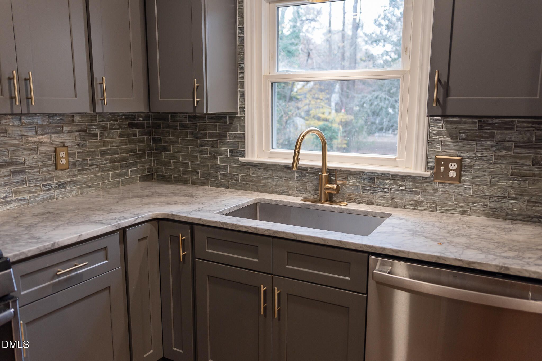 6708 Spencer Court Raleigh, NC 27615 - Photo 16 of 35 a kitchen with a sink a window and cabinets