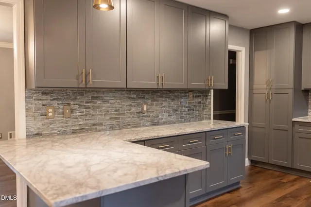 a kitchen with granite countertop a sink and cabinets