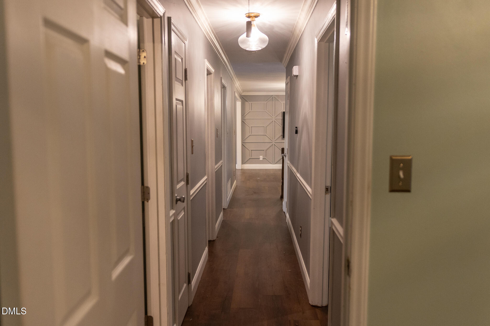 6708 Spencer Court Raleigh, NC 27615 - Photo 20 of 35 a view of a hallway with wooden floor and a mirror