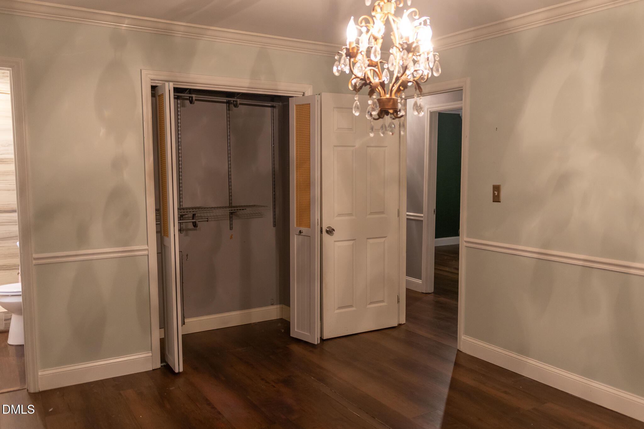 6708 Spencer Court Raleigh, NC 27615 - Photo 22 of 35 a view of a hallway with wooden floor and staircase