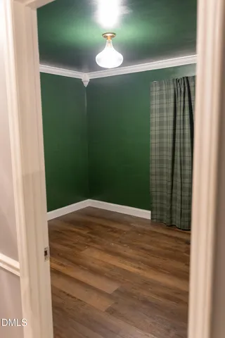 an empty room with wooden floor and closet