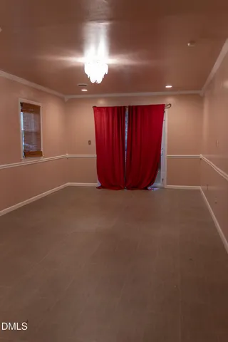 an empty room with closet and windows