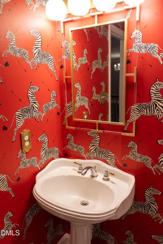 a white toilet sitting next to a bathroom sink and tub