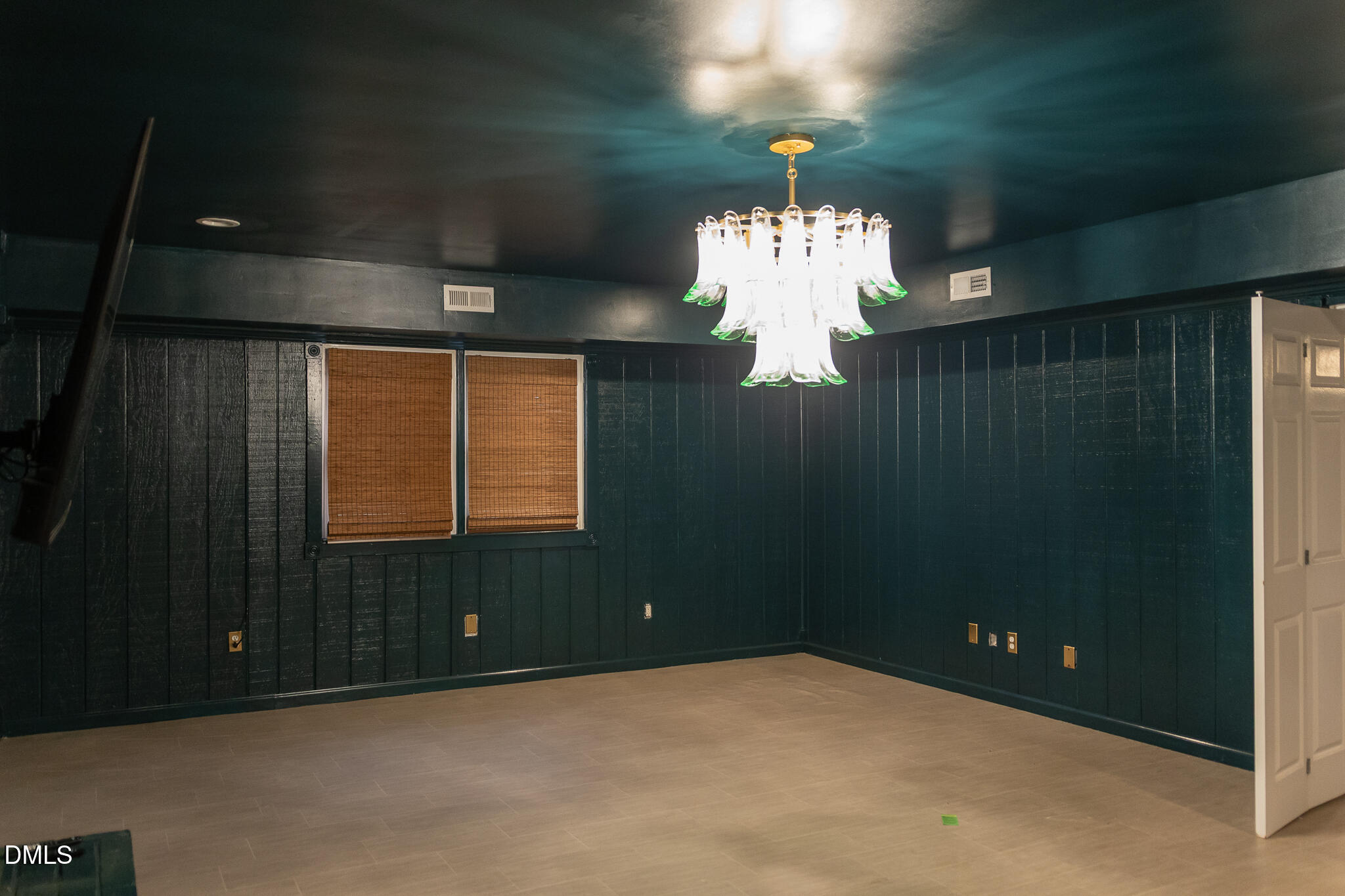 6708 Spencer Court Raleigh, NC 27615 - Photo 32 of 35 en empty room with windows and entrance