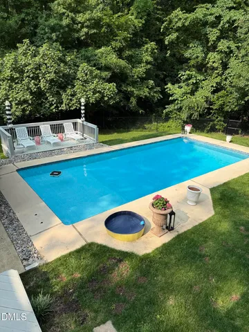 a view of a swimming pool with a yard
