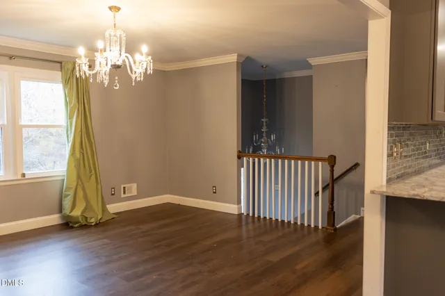 a view of a livingroom with wooden floor and a large window