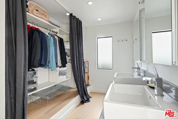 a bathroom with a tub sink and a mirror