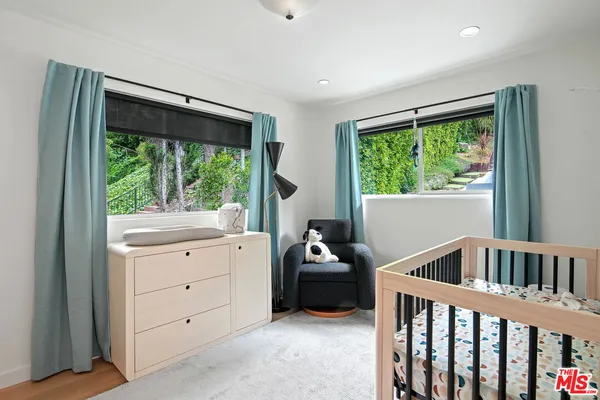 a bedroom with furniture and a window