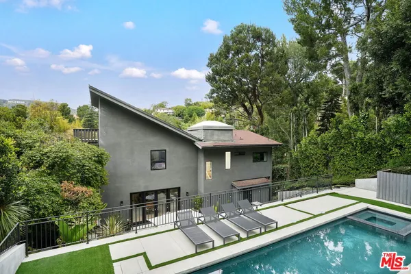 a view of house with yard entertaining space and sitting area