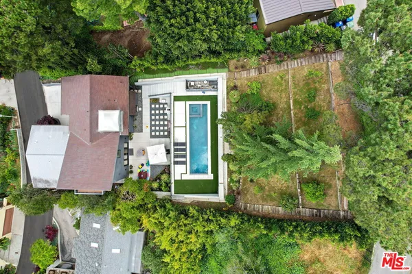 aerial view of a house with a yard and a garden