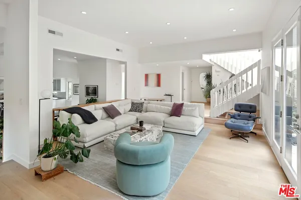 a living room with furniture and a potted plant