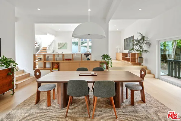 a dining room with furniture a window and a chandelier