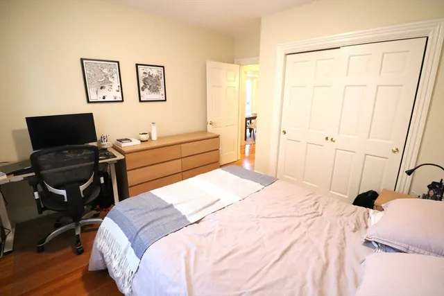 a bedroom with a bed and a desk