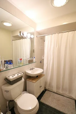 a bathroom with a sink a toilet and tub