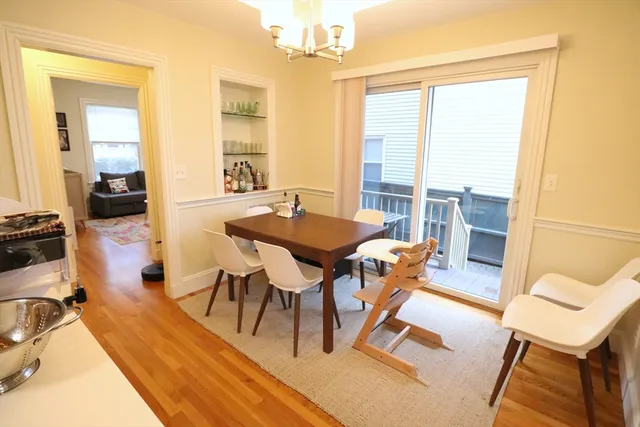 a view of a dining room with furniture wooden floor and a chandelier