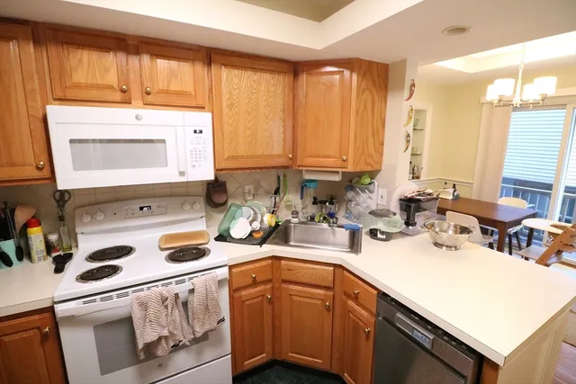 a kitchen with a sink a stove and cabinets