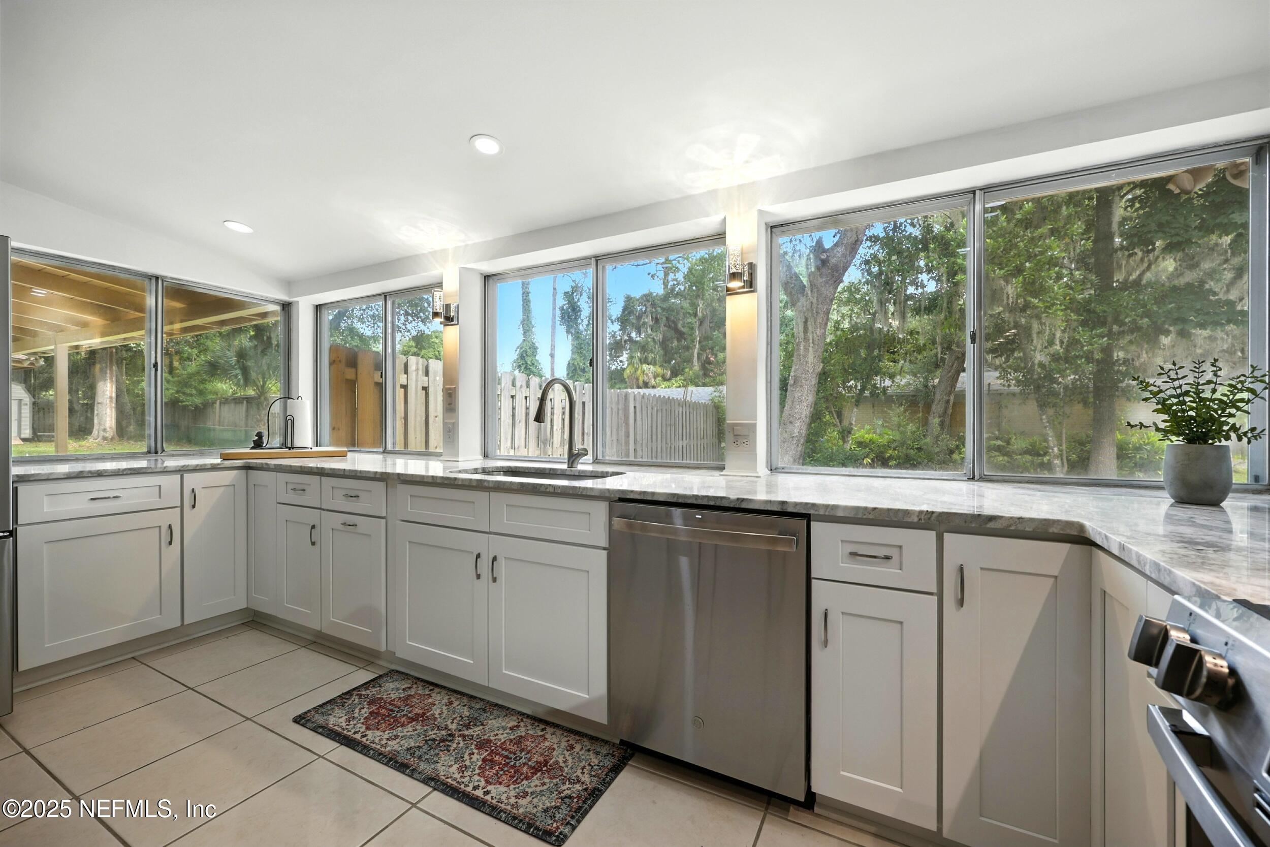 2712 Red Fox Road Orange Park, FL 32073 - Photo 11 of 30 a kitchen with a sink window and cabinets