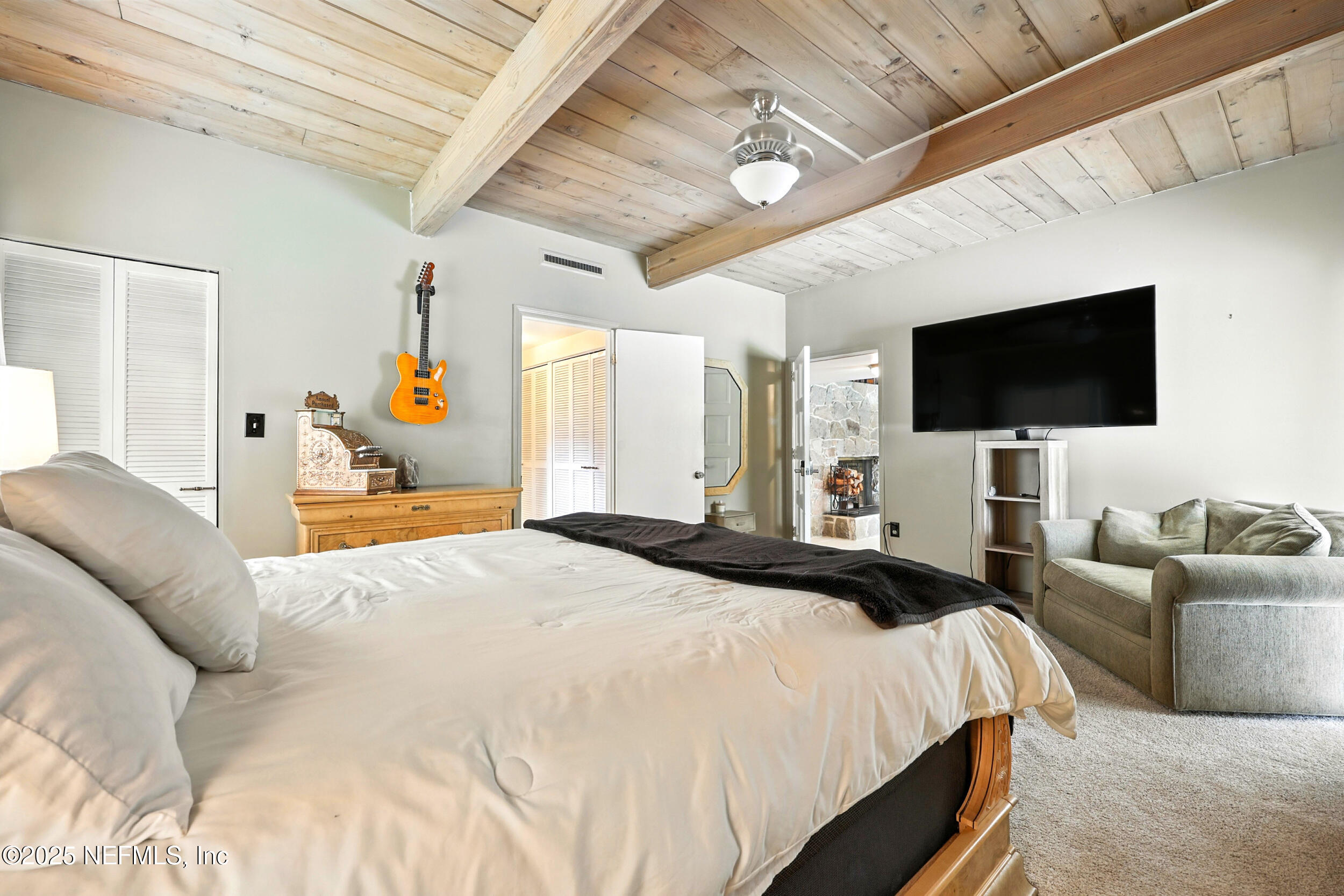 2712 Red Fox Road Orange Park, FL 32073 - Photo 18 of 30 a bedroom with a bed and a flat tv screen on dresser