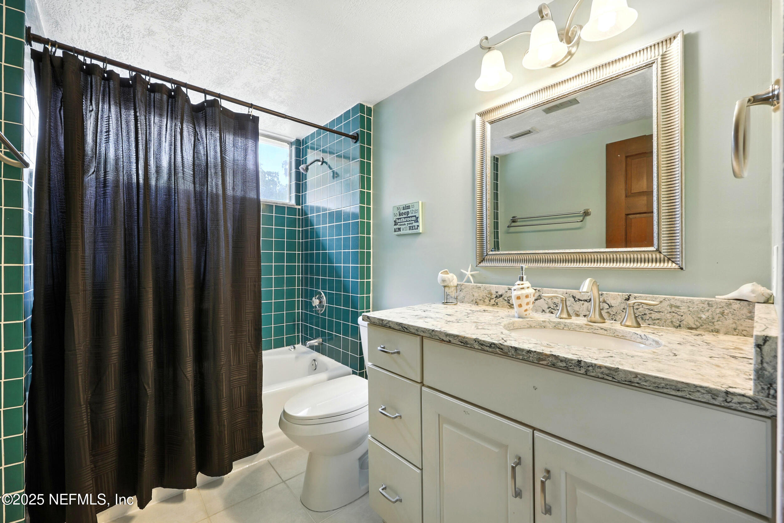 2712 Red Fox Road Orange Park, FL 32073 - Photo 24 of 30 a bathroom with a granite countertop sink vanity mirror and toilet