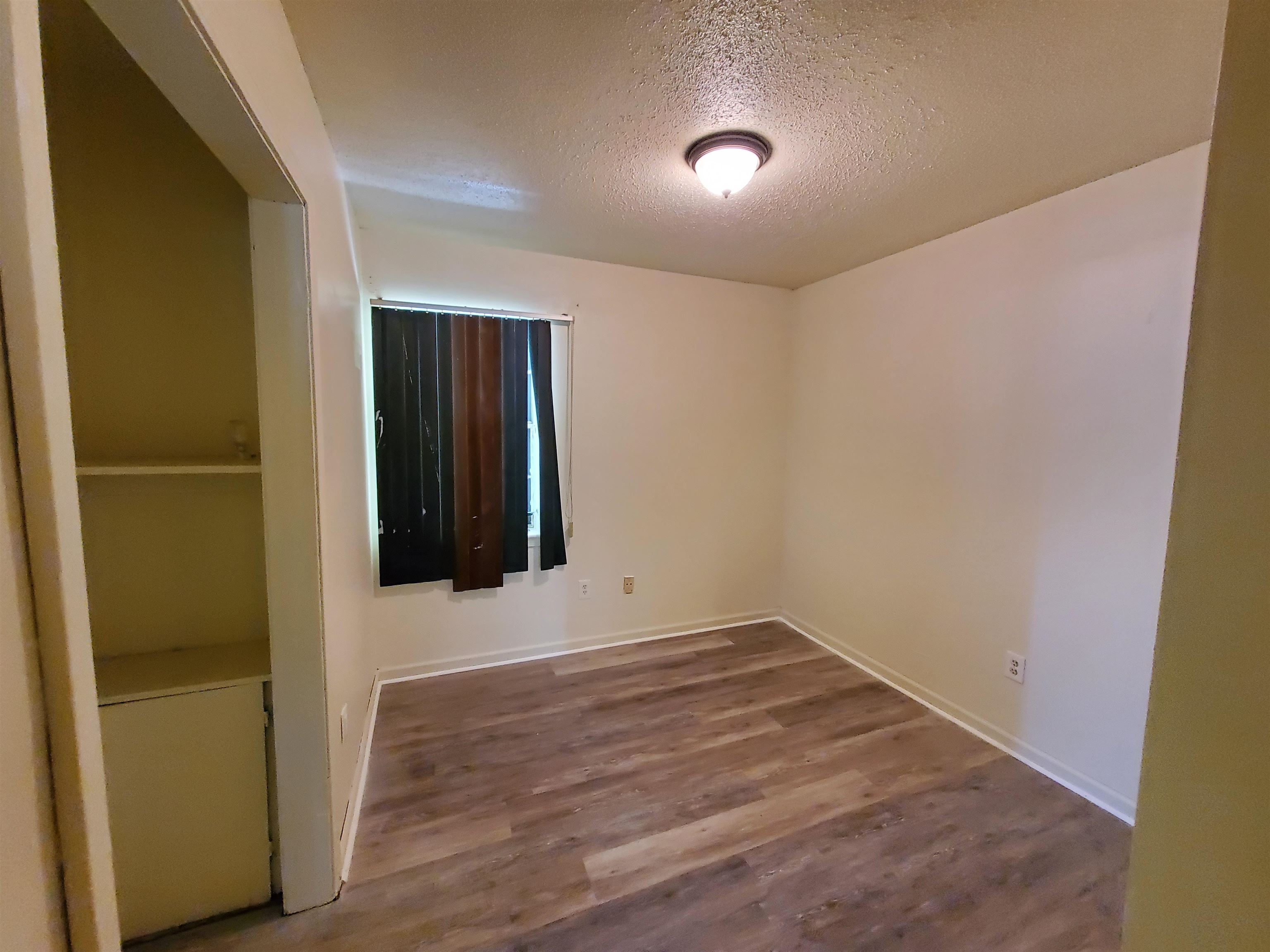 3440 Aaron Road Memphis, TN 38109 - Photo 6 of 16 an empty room with wooden floor and closet