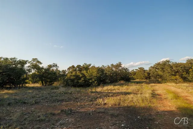 an aerial view of residential houses with outdoor space and ocean view