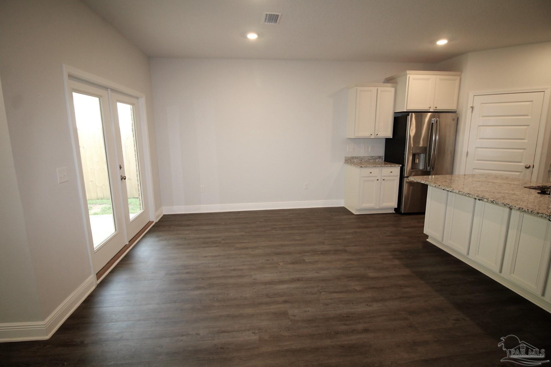 8006 Burnside Loop Pensacola, FL 32526 - Photo 11 of 22 an empty room with wooden floor and windows