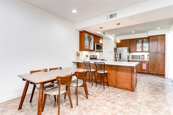 a living room with stainless steel appliances kitchen island granite countertop furniture and a kitchen view