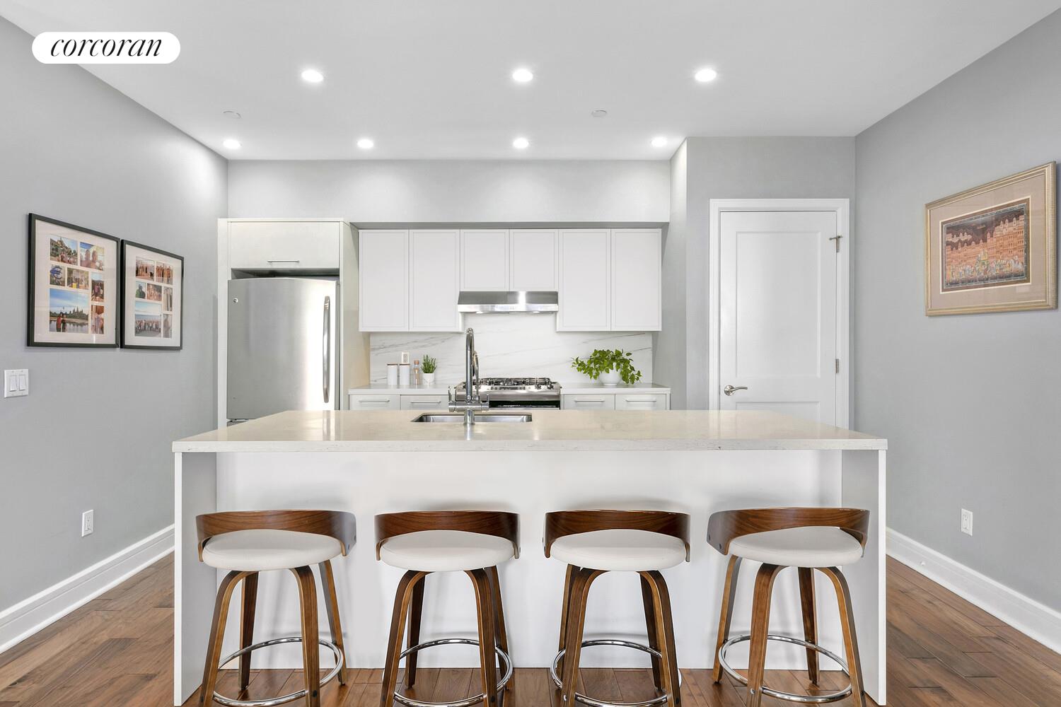 2255 Adam Clayton Powell Jr Boulevard, Unit 3A Manhattan, NY 10027 - Photo 2 of 9 a view of kitchen with granite countertop cabinets table and chairs