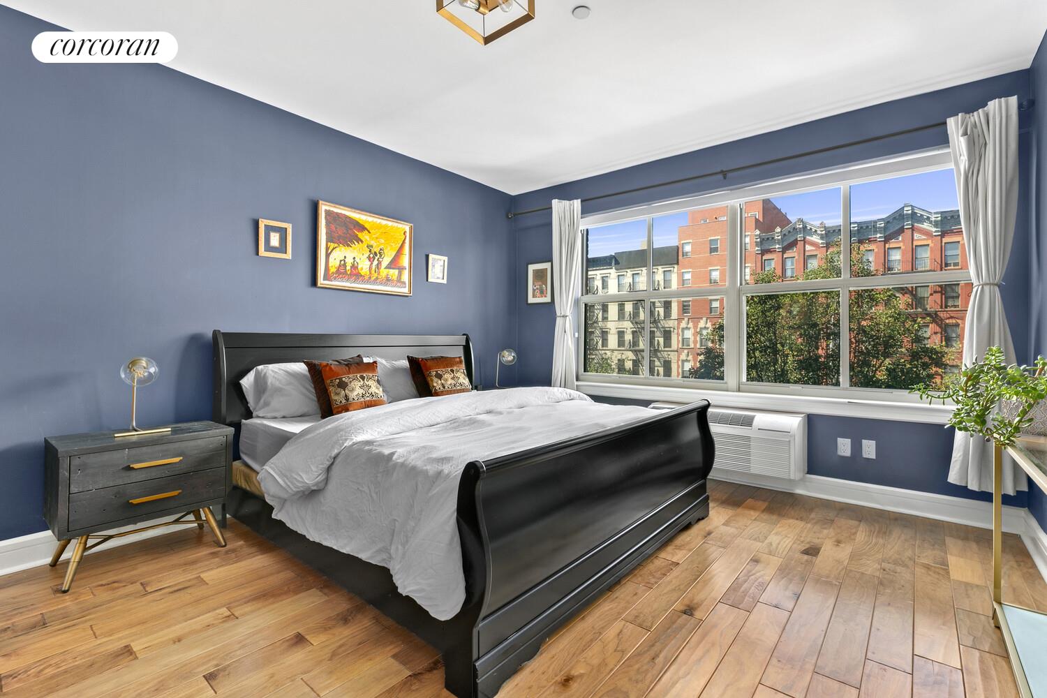 2255 Adam Clayton Powell Jr Boulevard, Unit 3A Manhattan, NY 10027 - Photo 4 of 9 a bedroom with a bed and a large window