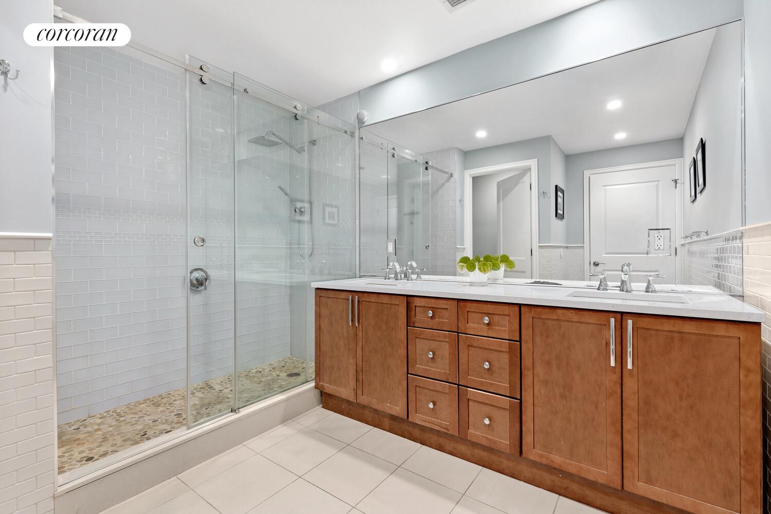 2255 Adam Clayton Powell Jr Boulevard, Unit 3A Manhattan, NY 10027 - Photo 5 of 9 a spacious bathroom with a granite countertop sink mirror and shower