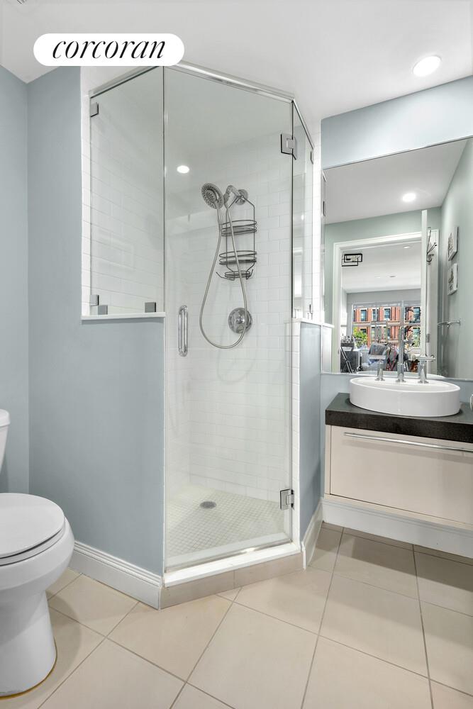 2255 Adam Clayton Powell Jr Boulevard, Unit 3A Manhattan, NY 10027 - Photo 8 of 9 a bathroom with a shower a mirror and a sink