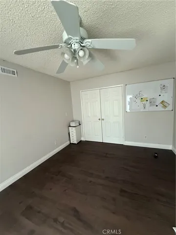 a view of a patio with table and chairs potted plants and floor to ceiling window
