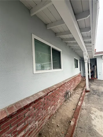 a living room with a large window and a fireplace